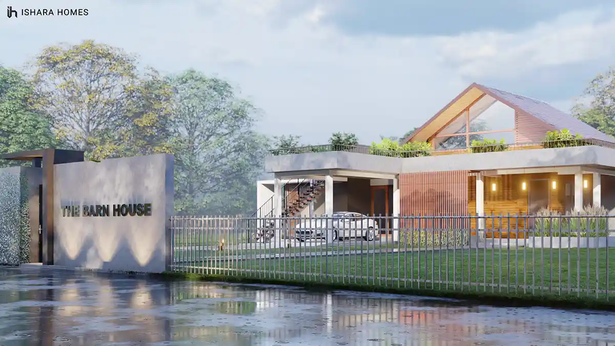At the gated entrance in daylight, the property sign stands before a metal fence, with the barn's dramatic gable roof, planted terrace and open...