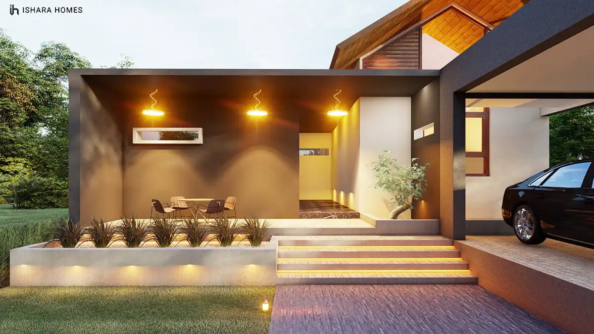 A closer evening view of the covered veranda shows pendant lights glowing above a small dining table, a dark timber door and a flight of...