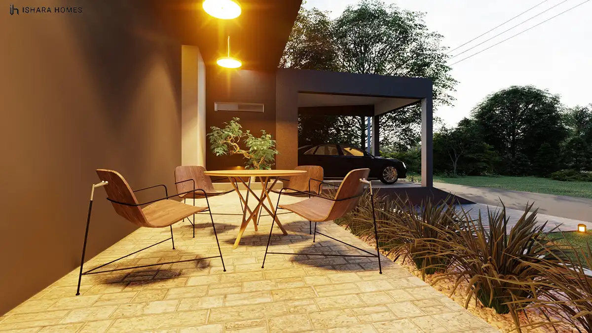 On the veranda at dusk, a wooden dining table and angular chairs sit beneath pendant lighting, with the carport and parked car visible just beyond...