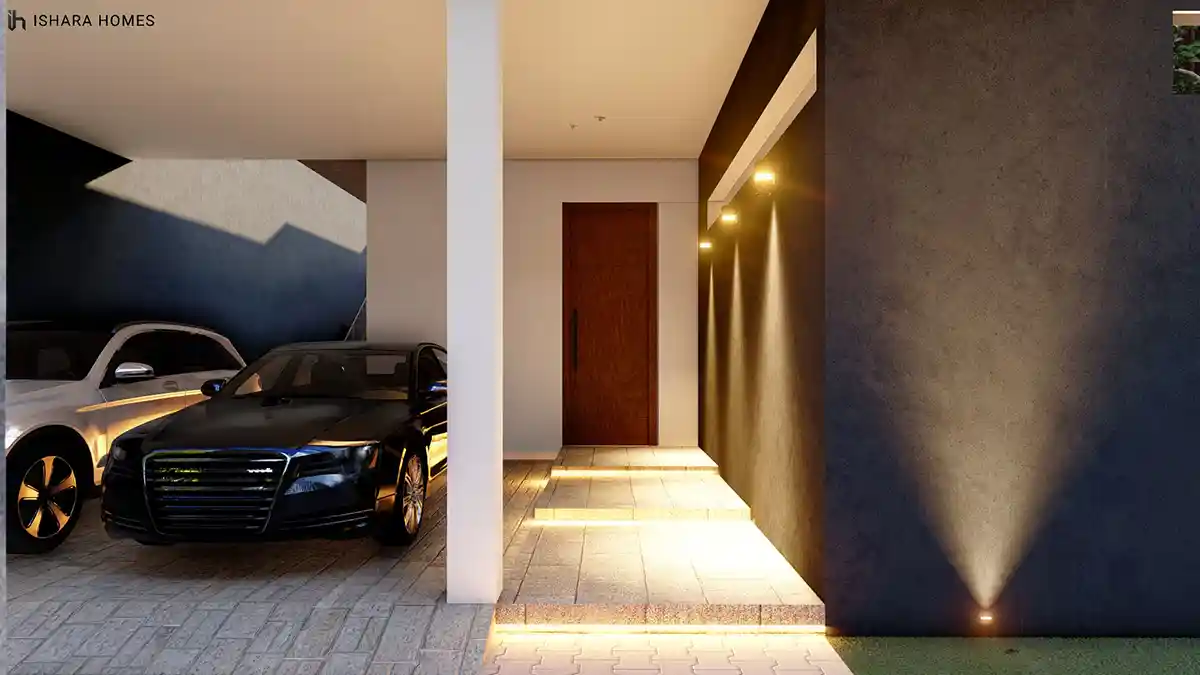 A close-up of the covered walkway shows a warm timber front door lit by a row of downlights against a dark textured wall, with illuminated steps...