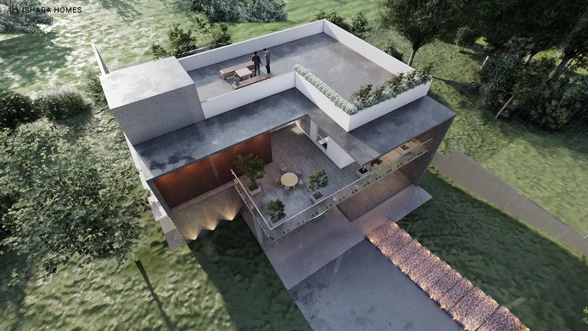 An aerial view reveals the rooftop terrace and lower deck in full, with a dining table, potted plants, and a stone-paved driveway winding through...