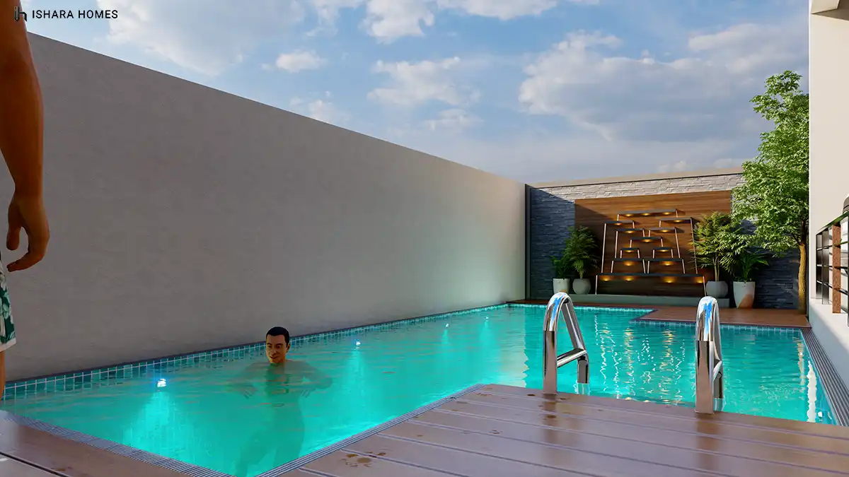 A swimmer relaxes in the private pool, where turquoise water meets timber decking beside a stacked-stone feature wall lit with a geometric...