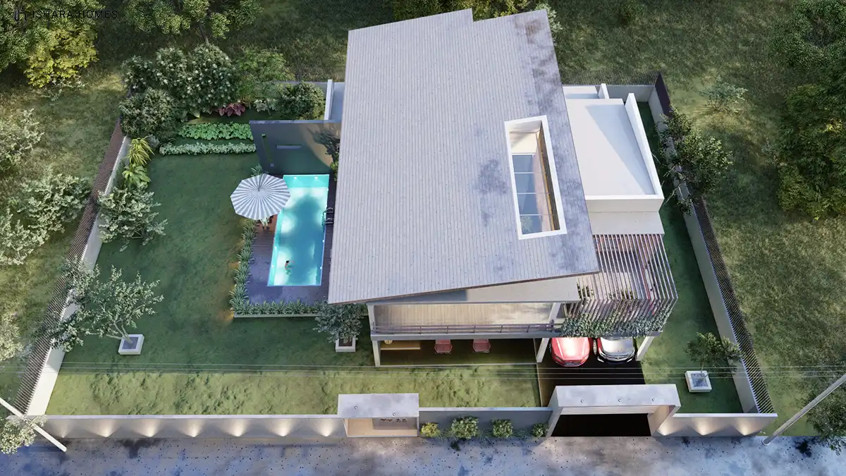 An aerial view of the property capturing the full shed-roof form, the rectangular pool, and the covered carport with vehicles parked below.