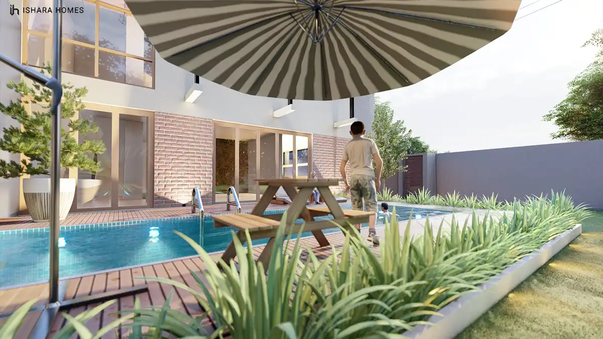 A ground-floor sitting nook by the entrance, its warm timber door and framed window seating area finished with soft pink lounge chairs.