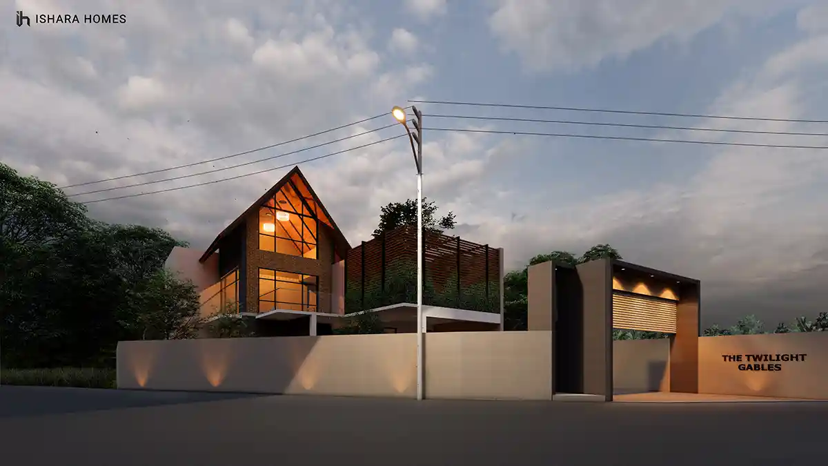 At dusk the property's entrance comes into focus, with the illuminated gable rising behind a low boundary wall and the signage for The Twilight...